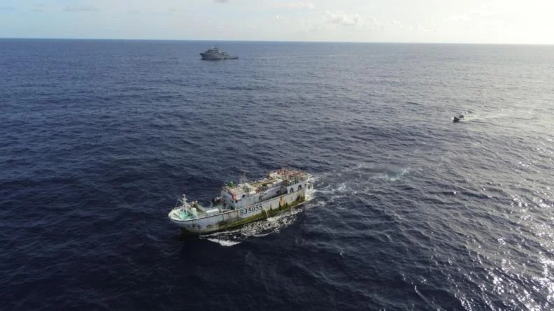 Le bâtiment de soutien Bougainville et un bateau de pêche